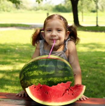 beauty little girl with watermelon summer scene