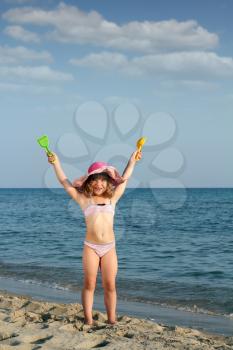 happy little girl on beach summer scene