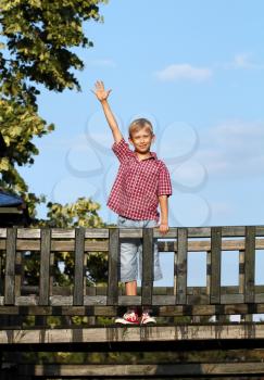 happy boy on wooden playground