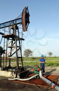 oil worker with tablet pc check pipeline