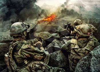 Patrol of norwegian Rapid reaction special forces FSK soldiers in field uniforms in ambush among the rocks guarding perimeter waiting enemy