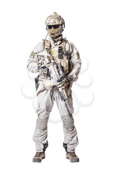 Army soldier in Protective Combat Uniform holding Special Operations Forces Combat Assault Rifle. Knee pads, mag recovery pouch, chest rig, military boots. Studio shot, isolated on white background
