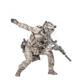 Army soldier, modern combatant, fireteam sergeant in battle uniform and helmet, armed with service rifle, duck under enemy fire, giving follow me arm signal studio shoot isolated on white background