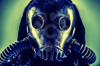 Close up portrait of nuclear post-apocalypse survivor, living underground mutant or creature, skilled stalker wearing rags and armored full-face gas mask or air breathing apparatus, toned shoot