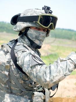 US soldier in camouflage uniform wearing helmet