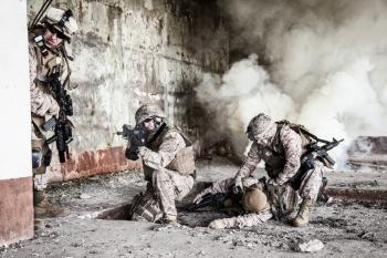 Squad of US marines in action in ruined building