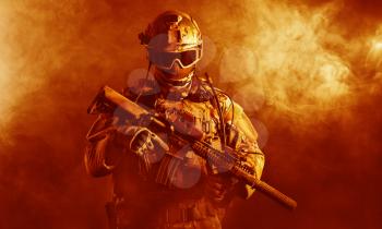 Special forces soldier with rifle in the fire