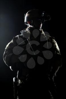 United States Army ranger with assault rifle on dark background