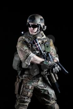 United States Army ranger with pistol on dark background