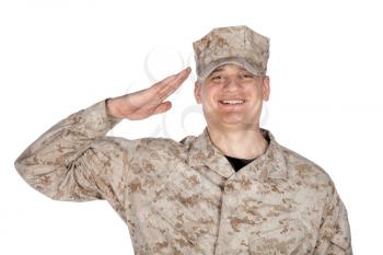 Shoulder studio portrait of smiling United States army soldier, marine infantry or military contractor in camouflage combat uniform and patrol cap showing hand salute, isolated on white background