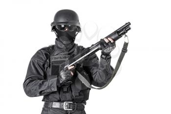 Spec ops police officer SWAT in black uniform with shotgun studio shot