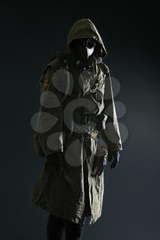 Nuclear post apocalypse. Studio shot of survivor in tatters and gas mask