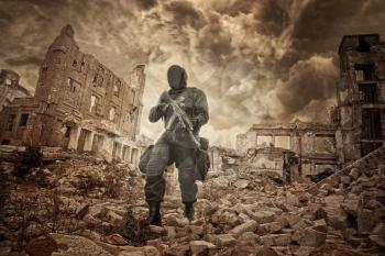 Post apocalypse. Sole survivor in tatters and gas mask on the ruins of the destroyed city