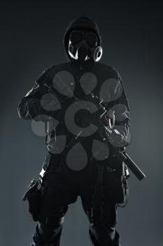 Nuclear post apocalypse. Studio shot of survivor with weapons and gas mask