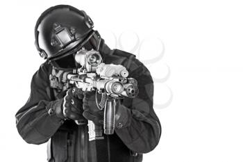 Studio shot of swat police special forces automatic rifle black uniforms pointing criminals. Tactical helmet vest goggles. Isolated on white