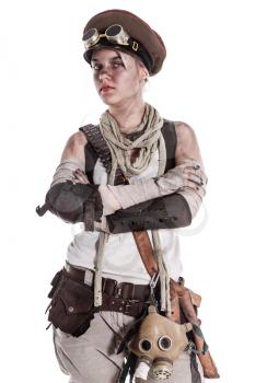 Nuclear post apocalypse life after doomsday concept. Grimy female survivor in tatters. Studio portrait on white background
