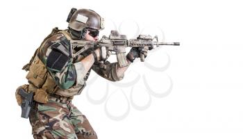 United states Marine Corps special operations command Marsoc raider with weapon aiming a gun. Studio shot of Marine Special Operator white background