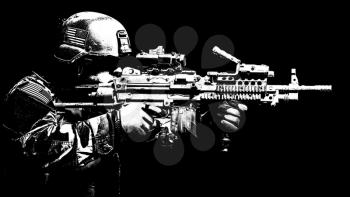 United states Marine Corps special operations command Marsoc raider with machine gun. Studio shot of Marine Special Operator black background