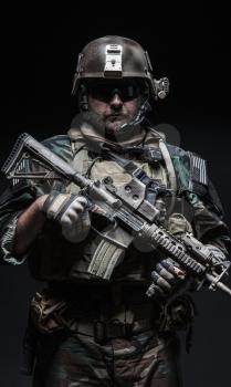 United states Marine Corps special operations command Marsoc raider with weapon. Studio shot of Marine Special Operator black background