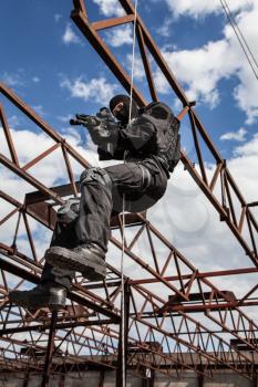 Special forces operator during assault rappeling with weapons