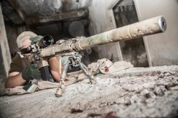 Navy Seal Sniper with rifle in action 