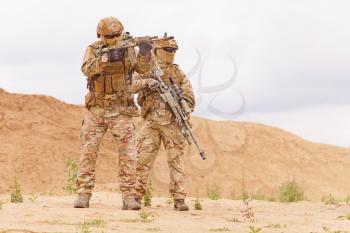 Two special forces snipers in the desert. Concept of military anti-terrorism operations, special operations of NATO forces.