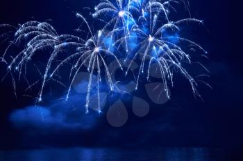 Blue colorful fireworks on the black sky background