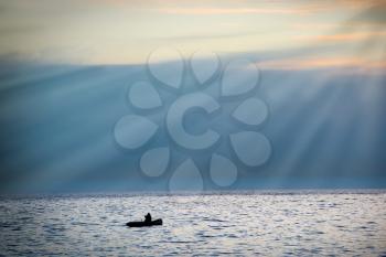 Sea landscape with boat against dramatic sunset