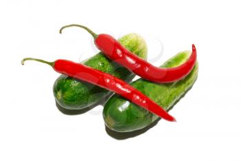 Cucumbers and red peppers isolated on white.