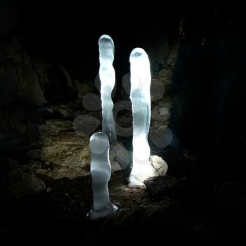 Luminescent ice stalagmites in the cave.