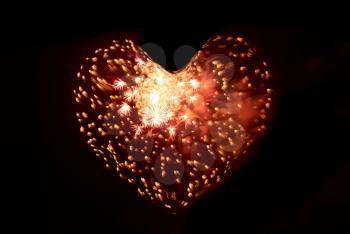 Heart from fireworks on the black sky background