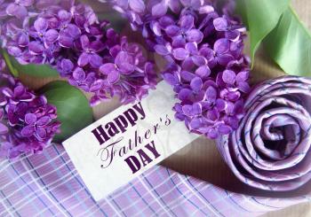 Beautiful purple lilac and tie for father's day. Greeting card. Abstract concept background for father's day celebration.