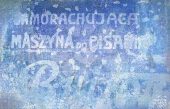 Text on old wall. Background of old cracked wall with Polish inscriptions. Ancient battered advertising wall inscription.