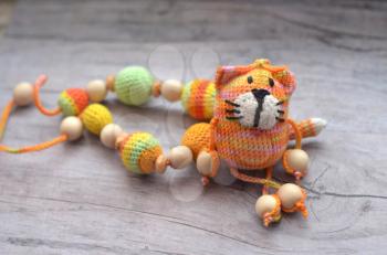 Knitted pink striped handmade crafted cat. Children's toy.
