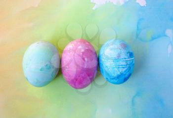 Watercolor background with colorful rainbow Easter eggs.