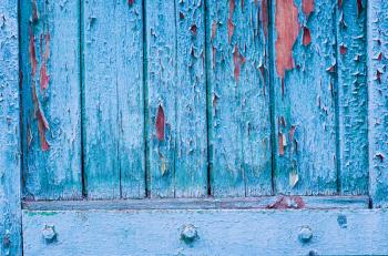 Vintage wooden background with faded turquoise peeling paint. Old wooden painted texture surface. Shabby Planks with cracked color paint.