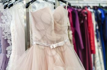 Evening dresses on hangers. Art of couture. Dresses for balls and celebrations
