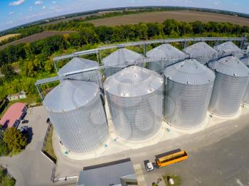 Flight of the grain terminal from the drone. The grain plant for storage and drying of grain. Grain terminal. Plant for the drying and storage Rice plant in the middle of fields.