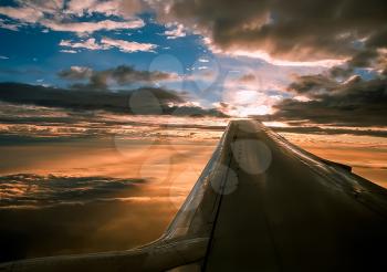 The view from the window of a passenger plane during the flight, the wing of the turbine engine of the aircraft.