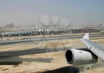 Airport in Dubai, the view from the plane. The view from the window of a passenger plane during the flight, the wing of the turbine engine of the aircraft.