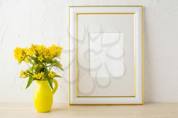 Frame mockup with small yellow flowers in stylized pitcher vase . Poster white frame mockup. Empty white frame mockup for presentation design.