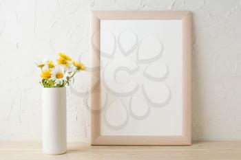Frame mockup with white and yellow chamomiles in vase. Poster white frame mockup. Empty white frame mockup for presentation design.