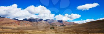 Beautiful steppe prairie landscape with mountains and blue sky with clouds panorama