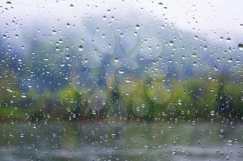 River view through window in rainy day. Rainy day. Rain drops. Rain drops background.