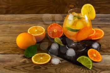Citrus drink on wooden table. Fruit lemonade. Summer drink. Citrus lemonade. Fruit cocktail. Fruit drink