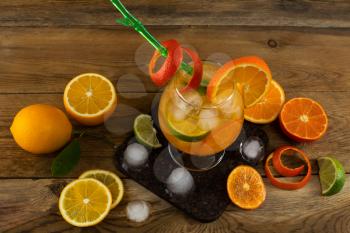 Fresh citrus drink on wooden table. Fruit lemonade. Summer drink. Citrus lemonade. Fruit cocktail. Fruit drink