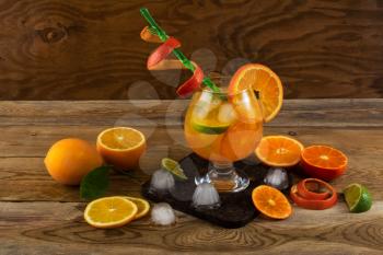 Summer citrus cocktail on wooden table. Fruit cocktail. Fruit drink. Citrus lemonade. Fruit lemonade. Summer drink 