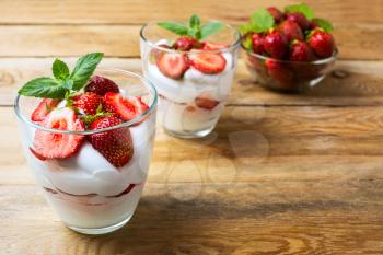 Strawberry summer layered dessert with whipped cream. Cream cheese with fresh strawberry. Copy space.