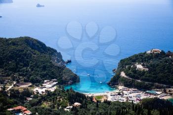 Island aerial view blue ocean behind. Beautiful Greek landscape. Corfu Greece natural places. Mountain next to sea water. Gorgeous place. Traveling to other countries