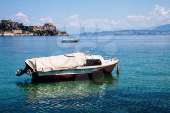 Boat trip along river in Corfu Greece. Ship on clean blue water. Island houses on the shore view. Greek beautiful landscape. White boats sailing. Relaxation, traveling